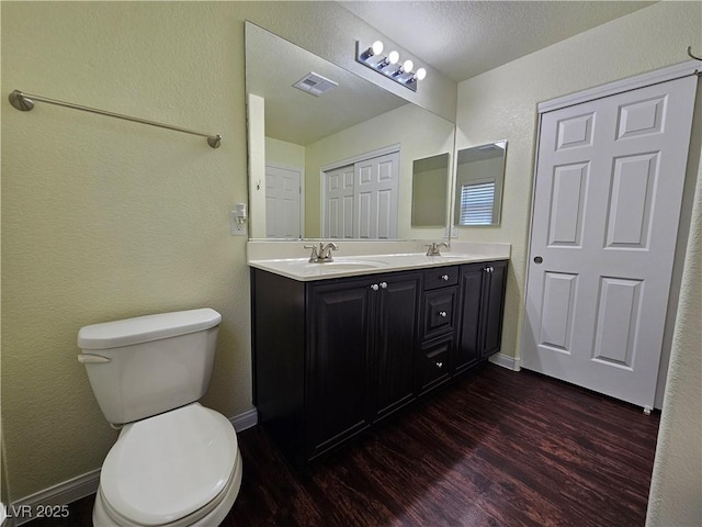 6824 Briarwood Bend Ave, Las Vegas, NV 89130 - full bathroom with wood finished floors, double vanity, and a textured wall