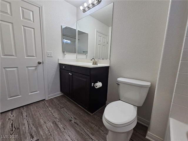 6824 Briarwood Bend Ave, Las Vegas, NV 89130 - bathroom featuring wood finished floors, vanity, a bathtub, and a textured wall