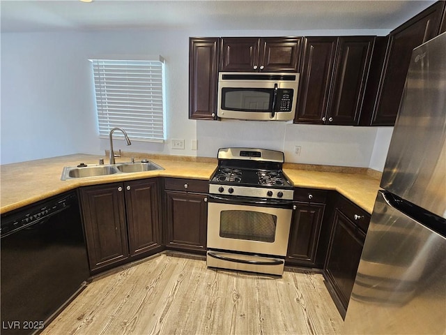6824 Briarwood Bend Ave, Las Vegas, NV 89130 - kitchen featuring appliances with stainless steel finishes, light countertops, and light wood finished floors