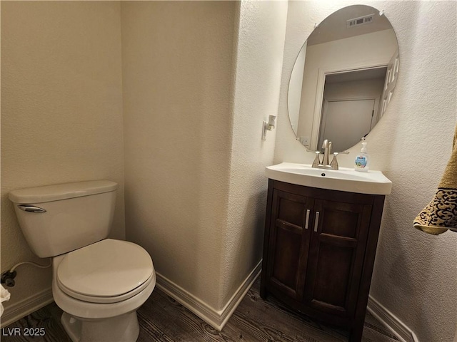 6824 Briarwood Bend Ave, Las Vegas, NV 89130 - half bathroom with wood finished floors, vanity, and a textured wall