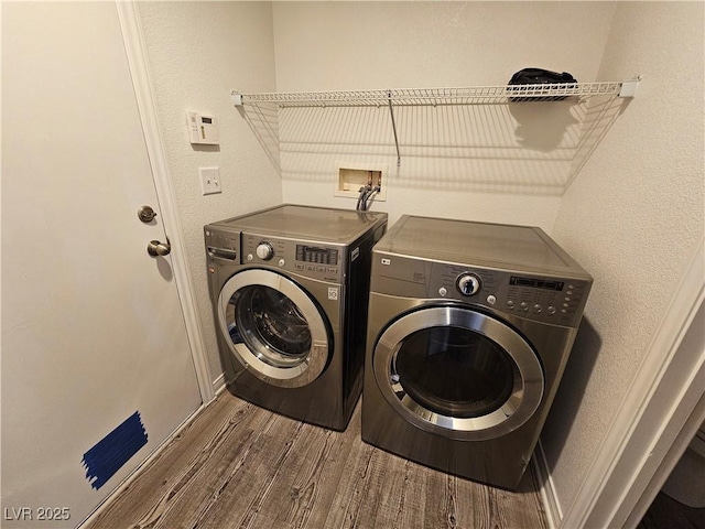 6824 Briarwood Bend Ave, Las Vegas, NV 89130 - washroom with washer and dryer, wood finished floors, and a textured wall