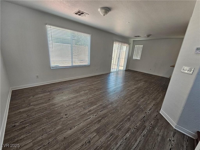 6824 Briarwood Bend Ave, Las Vegas, NV 89130 - empty room featuring dark wood-type flooring and a textured ceiling
