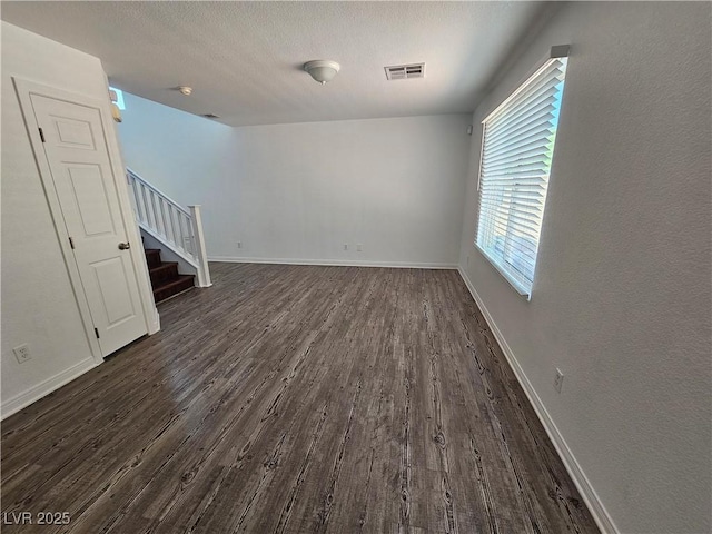 6824 Briarwood Bend Ave, Las Vegas, NV 89130 - spare room with stairs, dark wood-style flooring, and a textured ceiling