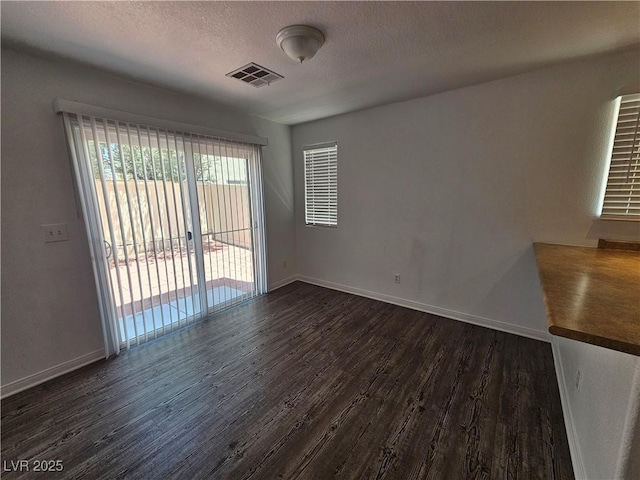 6824 Briarwood Bend Ave, Las Vegas, NV 89130 - unfurnished room with dark wood-style floors and a textured ceiling