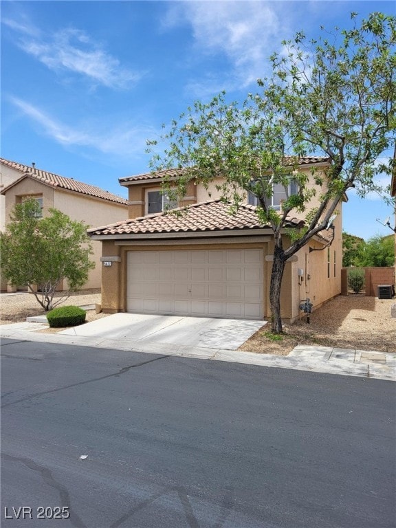5477 Ovando Way, Las Vegas, NV 89122 - mediterranean / spanish-style home with stucco siding, concrete driveway, a garage, and a tiled roof