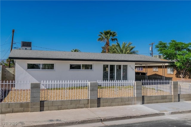 2105 Berkley Ave, Las Vegas, NV 89101 - ranch-style home featuring stucco siding, a fenced front yard, and a shingled roof
