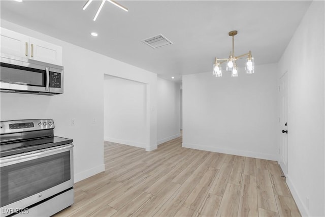 2105 Berkley Ave, Las Vegas, NV 89101 - kitchen featuring stainless steel appliances, a chandelier, light wood-type flooring, white cabinets, and recessed lighting