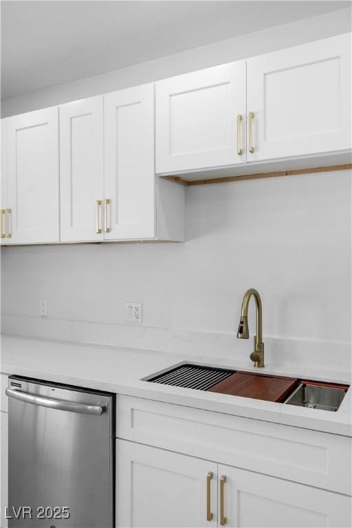 2105 Berkley Ave, Las Vegas, NV 89101 - kitchen featuring stainless steel dishwasher, light countertops, white cabinetry, and backsplash
