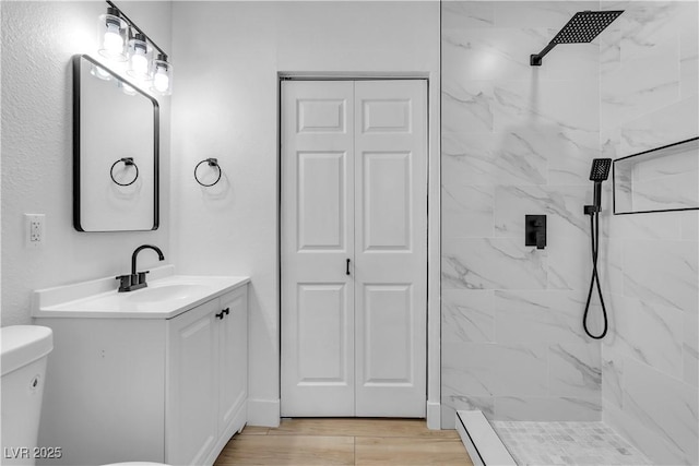 2105 Berkley Ave, Las Vegas, NV 89101 - bathroom featuring a marble finish shower, vanity, a closet, and wood finished floors