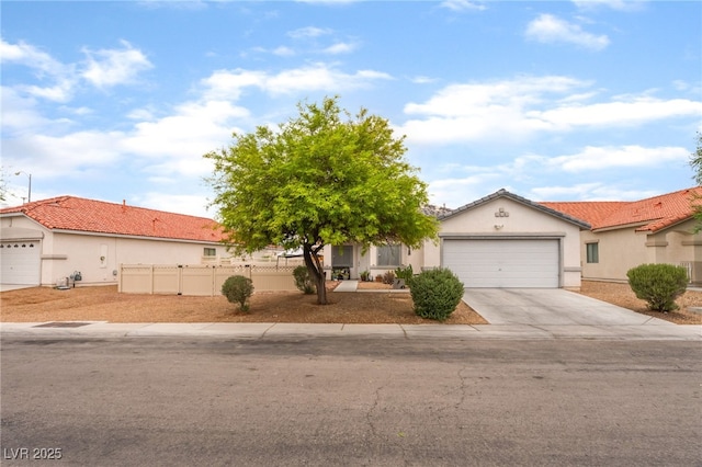 5733 Dazzling Sparks St, North Las Vegas, NV 89031 - view of front of house featuring an attached garage, driveway, and stucco siding
