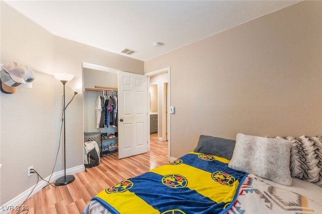 5733 Dazzling Sparks St, North Las Vegas, NV 89031 - bedroom with wood finished floors and a closet