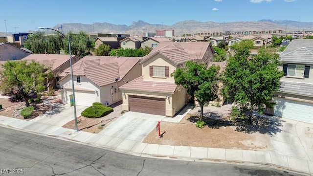 7137 Eyebright St, Las Vegas, NV 89131 - view of front of property with a residential view, stucco siding, a mountain view, driveway, and an attached garage