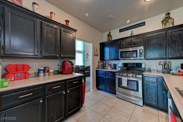 7137 Eyebright St, Las Vegas, NV 89131 - kitchen featuring stainless steel appliances, light countertops, and light tile patterned flooring
