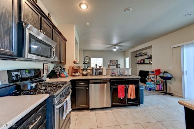 7137 Eyebright St, Las Vegas, NV 89131 - kitchen featuring stainless steel appliances, light countertops, a peninsula, a ceiling fan, and light tile patterned floors