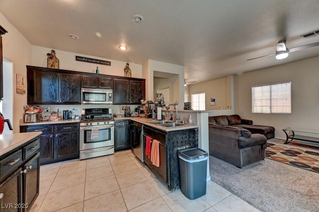 7137 Eyebright St, Las Vegas, NV 89131 - kitchen featuring stainless steel appliances, open floor plan, light countertops, ceiling fan, and a peninsula
