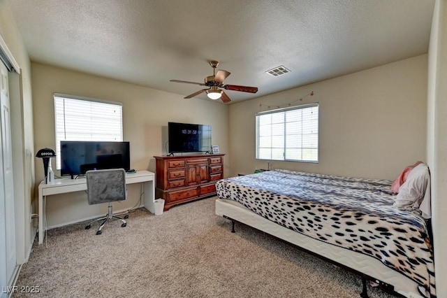 7137 Eyebright St, Las Vegas, NV 89131 - bedroom with multiple windows, carpet flooring, a textured ceiling, a desk, and ceiling fan