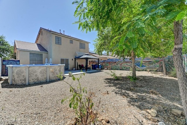 7137 Eyebright St, Las Vegas, NV 89131 - rear view of house featuring a gazebo, stucco siding, an outdoor pool, and a patio