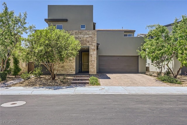 1213 Granite Falls Pl, North Las Vegas, NV 89084 - modern home featuring stucco siding, decorative driveway, stone siding, and a garage