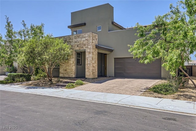 1213 Granite Falls Pl, North Las Vegas, NV 89084 - view of front of house featuring decorative driveway, stone siding, and stucco siding