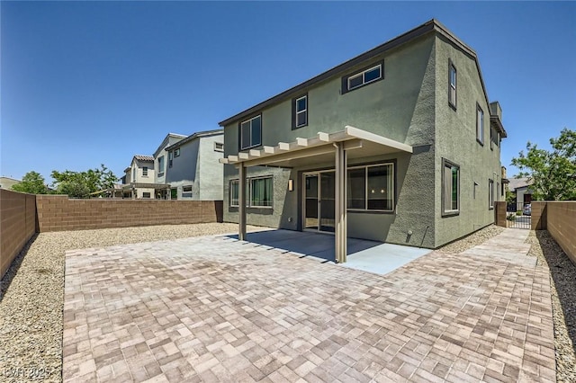 1213 Granite Falls Pl, North Las Vegas, NV 89084 - rear view of house with stucco siding, a patio, and a fenced backyard