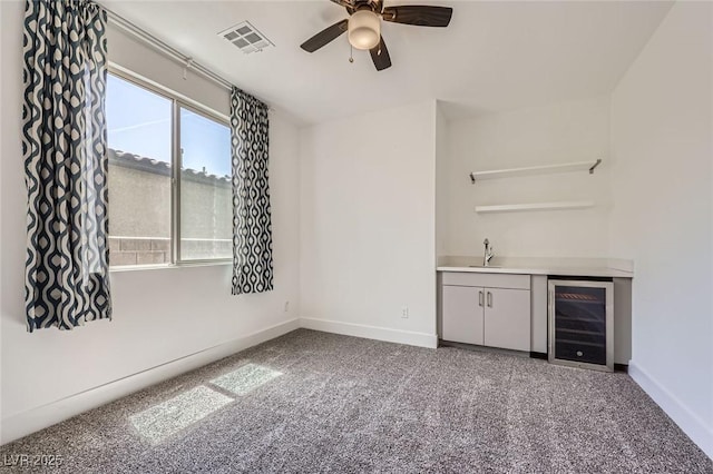 1213 Granite Falls Pl, North Las Vegas, NV 89084 - indoor wet bar with beverage cooler, a ceiling fan, and carpet flooring