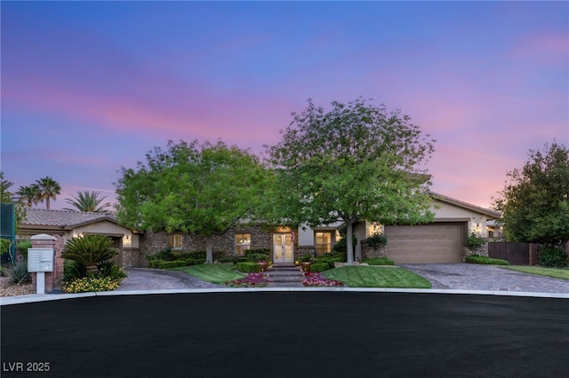 2285 Villefort Ct, Las Vegas, NV 89117 - view of front facade featuring driveway, a garage, stone siding, french doors, and stucco siding