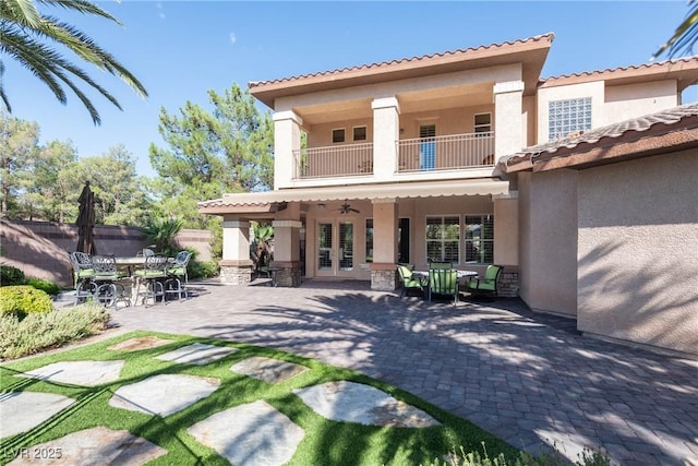 2285 Villefort Ct, Las Vegas, NV 89117 - back of property featuring a balcony, stucco siding, outdoor dining area, and a patio