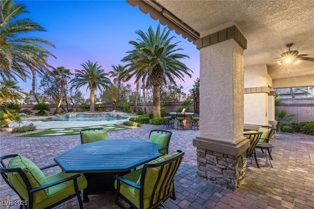 2285 Villefort Ct, Las Vegas, NV 89117 - patio terrace at dusk featuring outdoor dining area, a patio area, a fenced backyard, and an outdoor pool