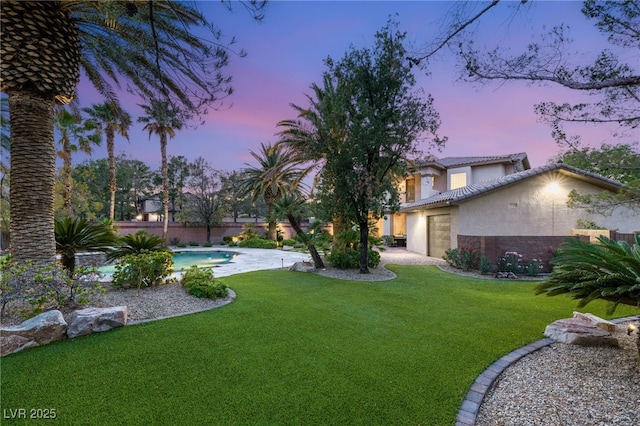 2285 Villefort Ct, Las Vegas, NV 89117 - yard at dusk with a garage, an outdoor pool, and driveway