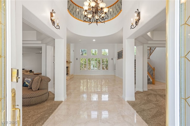 2285 Villefort Ct, Las Vegas, NV 89117 - foyer with stairs, a chandelier, light carpet, a high ceiling, and light marble finish floors