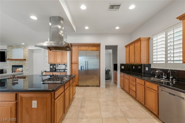 2285 Villefort Ct, Las Vegas, NV 89117 - kitchen featuring appliances with stainless steel finishes, island range hood, tasteful backsplash, recessed lighting, and open floor plan