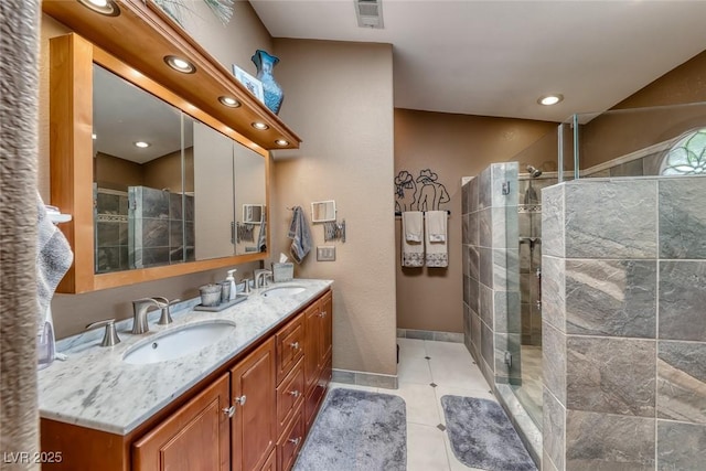 4045 N Chieftain St, Las Vegas, NV 89129 - bathroom featuring double vanity, tiled shower, tile patterned floors, and recessed lighting