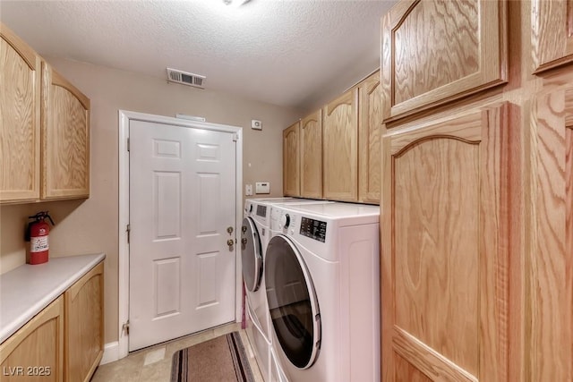 4045 N Chieftain St, Las Vegas, NV 89129 - laundry area featuring cabinet space, independent washer and dryer, and a textured ceiling