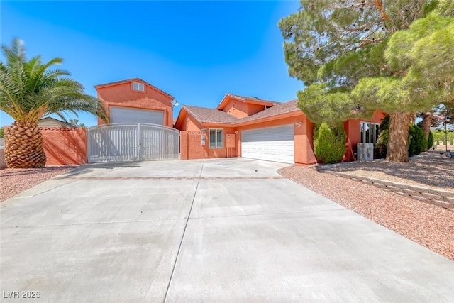 4045 N Chieftain St, Las Vegas, NV 89129 - view of front of home featuring a gate, a garage, driveway, and stucco siding