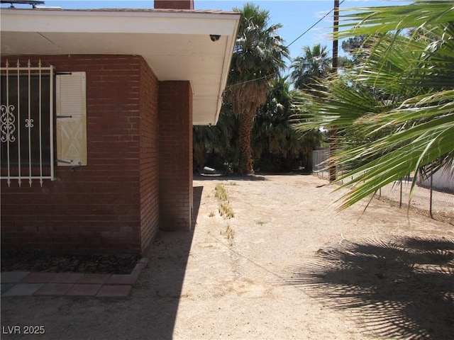 4950 Burnham Ave, Las Vegas, NV 89119 - view of property exterior featuring brick siding and a chimney