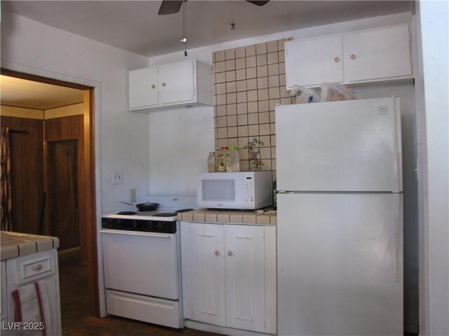 4950 Burnham Ave, Las Vegas, NV 89119 - kitchen featuring white appliances, tile countertops, white cabinets, and ceiling fan