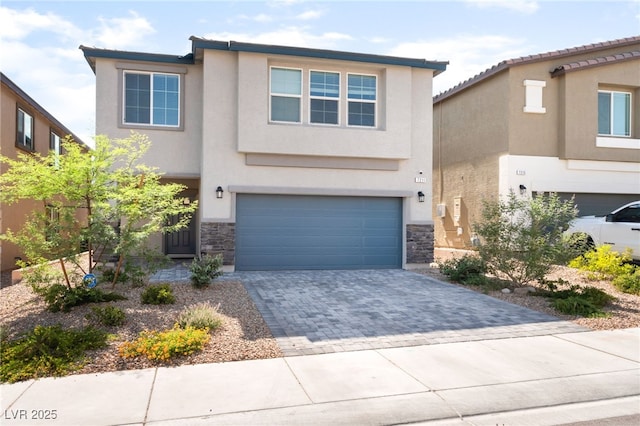 7211 Alabaster Peak St, Las Vegas, NV 89166 - view of front of property featuring a garage, stone siding, stucco siding, and decorative driveway