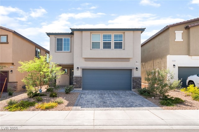 7211 Alabaster Peak St, Las Vegas, NV 89166 - view of front of property with an attached garage, stone siding, decorative driveway, and stucco siding