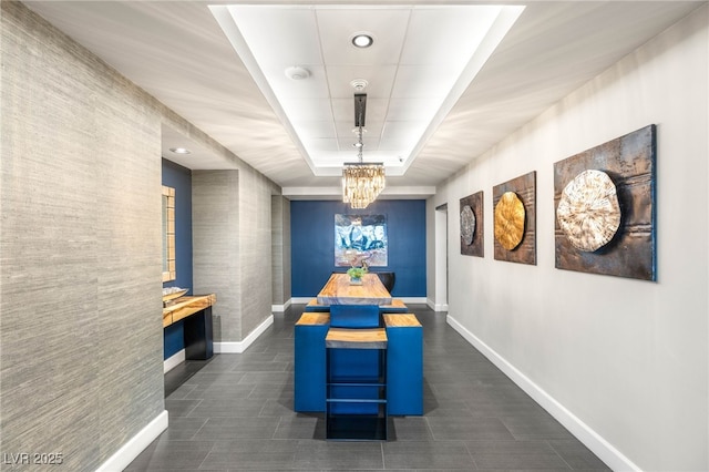 200 W Sahara Ave Unit 2204, Las Vegas, NV 89102 - dining area featuring a tray ceiling, a chandelier, and dark tile patterned floors
