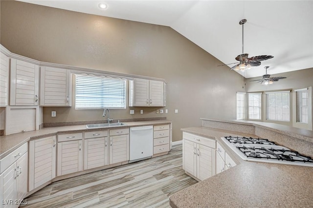 819 Sandsprings St, Henderson, NV 89011 - kitchen featuring white appliances, a ceiling fan, white cabinetry, light countertops, and high vaulted ceiling