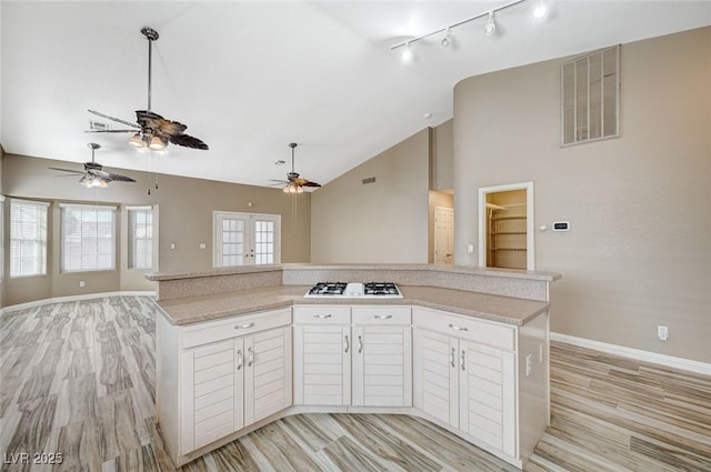 819 Sandsprings St, Henderson, NV 89011 - kitchen featuring a ceiling fan, white gas cooktop, track lighting, light countertops, and high vaulted ceiling
