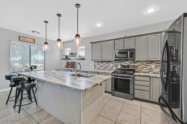 3591 Gloucester Gate St, Las Vegas, NV 89122 - kitchen with stainless steel appliances, gray cabinetry, backsplash, light tile patterned flooring, and recessed lighting