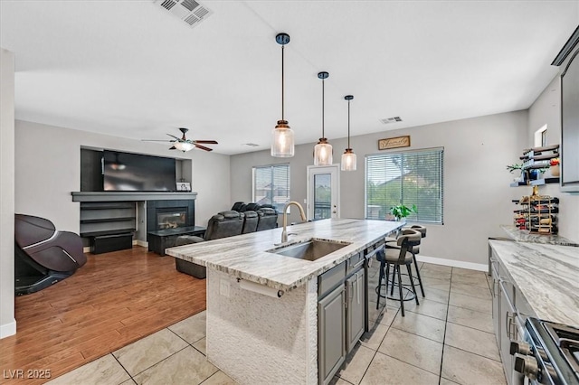 3591 Gloucester Gate St, Las Vegas, NV 89122 - kitchen with stainless steel range oven, dishwashing machine, a ceiling fan, light tile patterned floors, and hanging light fixtures