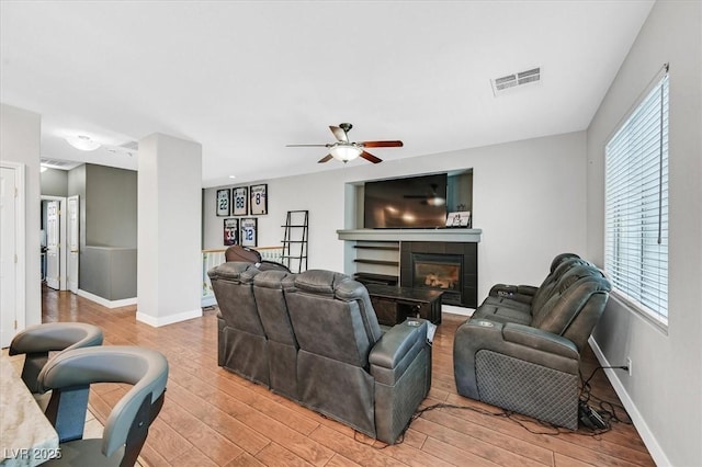 3591 Gloucester Gate St, Las Vegas, NV 89122 - living room with light wood-type flooring, ceiling fan, and a tile fireplace
