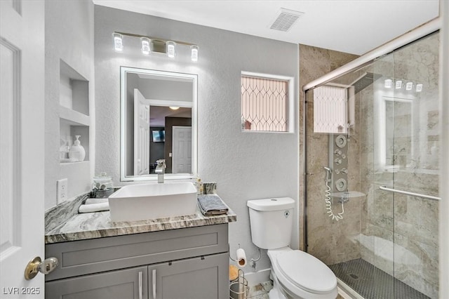 3591 Gloucester Gate St, Las Vegas, NV 89122 - bathroom featuring vanity, a textured wall, and a shower stall
