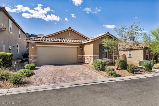 8346 Vinamala Ave, Las Vegas, NV 89149 - mediterranean / spanish house featuring stone siding, a tile roof, stucco siding, a garage, and driveway