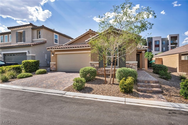 8346 Vinamala Ave, Las Vegas, NV 89149 - view of front of house featuring stone siding, stucco siding, decorative driveway, an attached garage, and a tile roof
