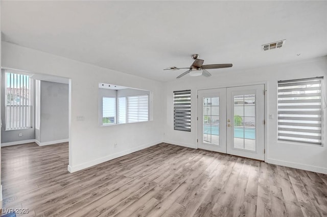 5823 Rose Sage St, North Las Vegas, NV 89031 - unfurnished room featuring healthy amount of natural light, ceiling fan, wood finished floors, and french doors