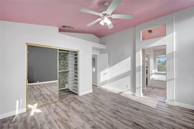 5823 Rose Sage St, North Las Vegas, NV 89031 - unfurnished bedroom with wood finished floors, vaulted ceiling, ceiling fan, a closet, and ensuite bath