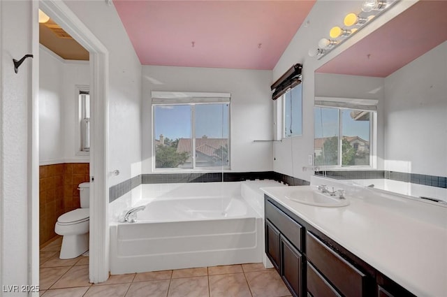 5823 Rose Sage St, North Las Vegas, NV 89031 - full bath with a garden tub, vanity, tile patterned flooring, a wainscoted wall, and tile walls